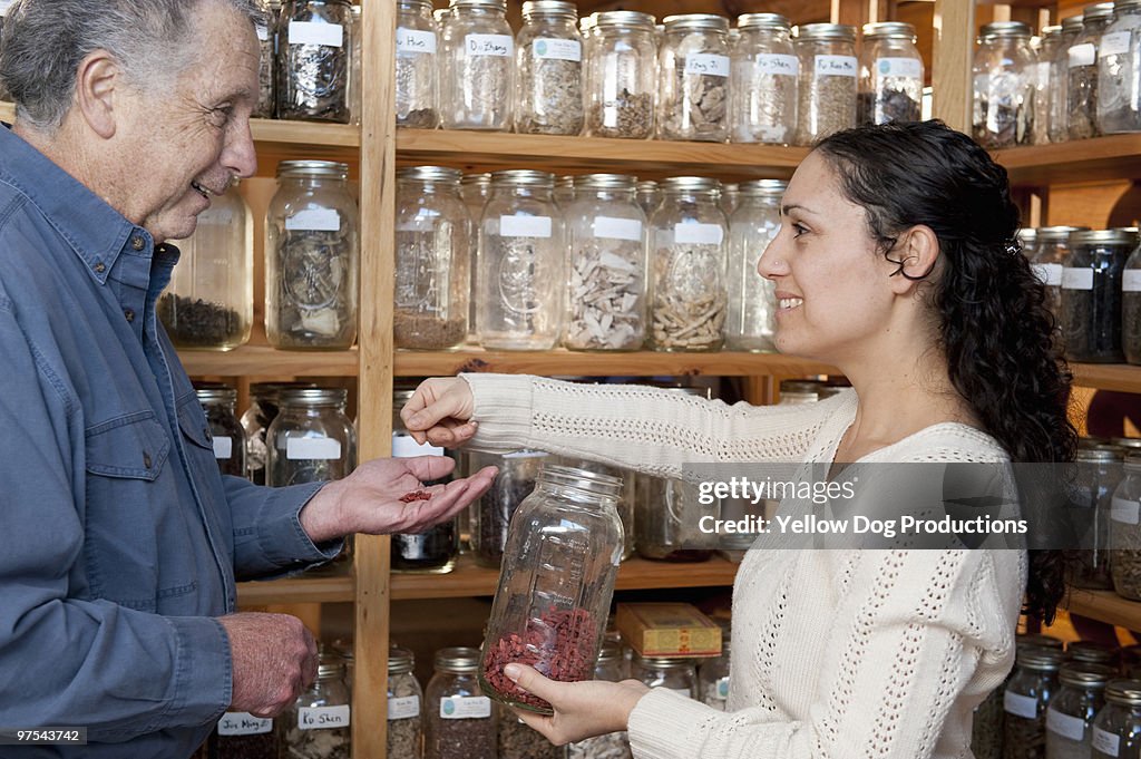 Herballist giving herbs to client
