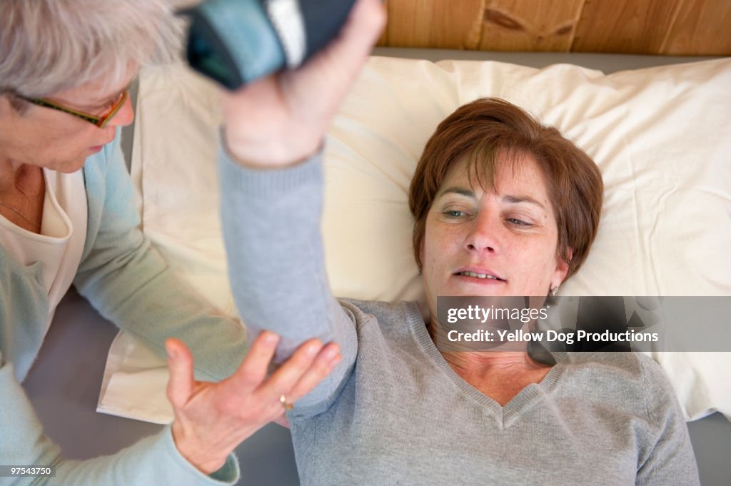 Physical therapist helping patient