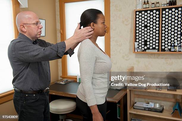 chiropractor examining patient  - manchester vermont foto e immagini stock