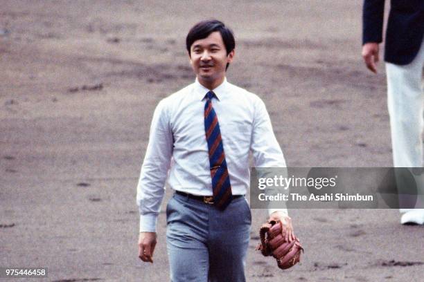 Prince Naruhito throws a ceremonial first pitch during the opening ceremony of the 70th All Japan High School Baseball Tournament at Hanshin Koshien...