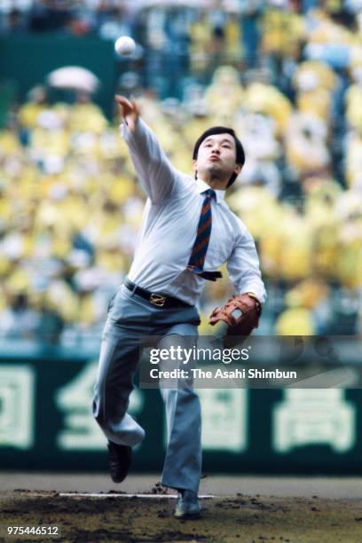 Prince Naruhito throws a ceremonial first pitch during the opening ceremony of the 70th All Japan High School Baseball Tournament at Hanshin Koshien...