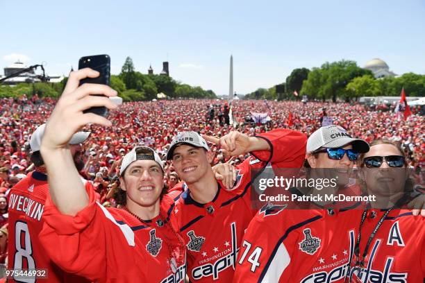 Oshie, Andre Burakovsky, John Carlson, and Nicklas Backstrom of the Washington Capitals take photos during the Washington Capitals Victory Parade And...