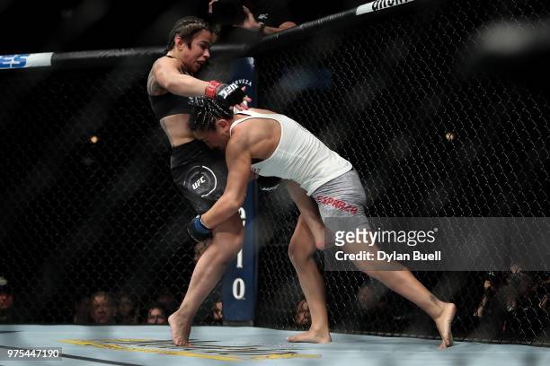 Carla Esparza attempts to take down Claudia Gadelha of Brazil in the second round in their strawweight bout during the UFC 225: Whittaker v Romero 2...