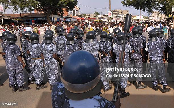 Togolese gendarmes and police forces prepare to charge supporters of Jean-Pierre Fabre, leader of the Union of Forces of Change , the main party of...