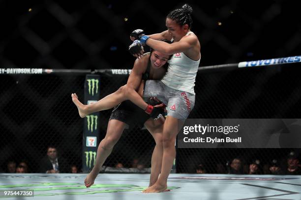 Claudia Gadelha of Brazil attempts to take down Carla Esparza in the second round in their strawweight bout during the UFC 225: Whittaker v Romero 2...