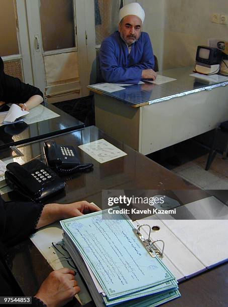 Certificates of temporary marriage filed in a registry office run by a clergyman in Tehran, October 2000. Shia Islam allows a man and woman to marry...