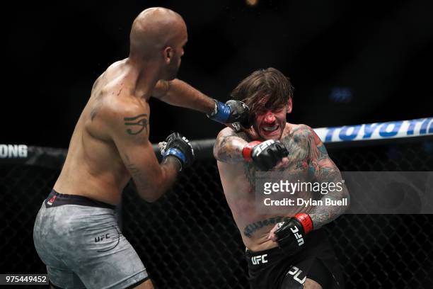 Mike Jackson lands a punch against CM Punk in the first round in their welterweight bout during the UFC 225: Whittaker v Romero 2 event at the United...