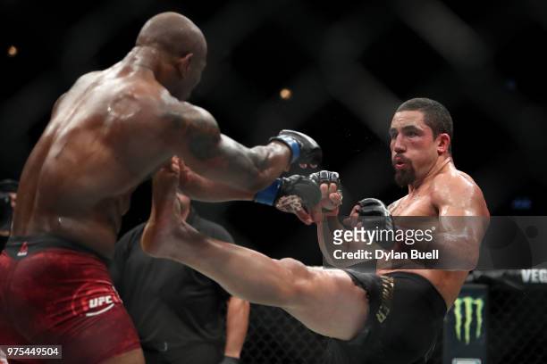 Robert Whittaker of New Zealand attempts a kick against Yoel Romero of Cuba in the fourth round in their middleweight title fight during the UFC 225:...