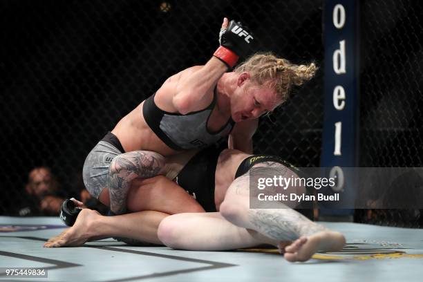 Holly Holm punches Megan Anderson of Australia in the third round in their featherweight bout during the UFC 225: Whittaker v Romero 2 event at the...