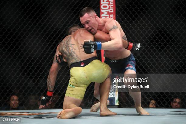 Colby Covington attempts to take down Rafael Dos Anjos of Brazil in the third round in their welterweight title fight during the UFC 225: Whittaker v...