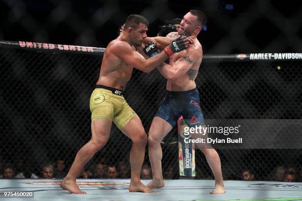 Colby Covington and Rafael Dos Anjos of Brazil grapple in the third round in their welterweight title fight during the UFC 225: Whittaker v Romero 2...