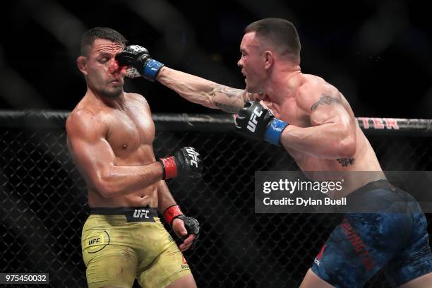 Colby Covington lands a punch against Rafael Dos Anjos of Brazil in the third in during their welterweight title fight during the UFC 225: Whittaker...