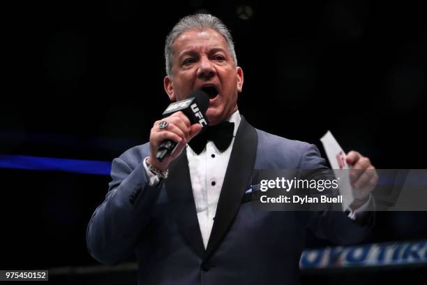 Octagon announcer Bruce Buffer introduces Rafael Dos Anjos of Brazil and Colby Covington before their welterweight title fight during the UFC 225:...