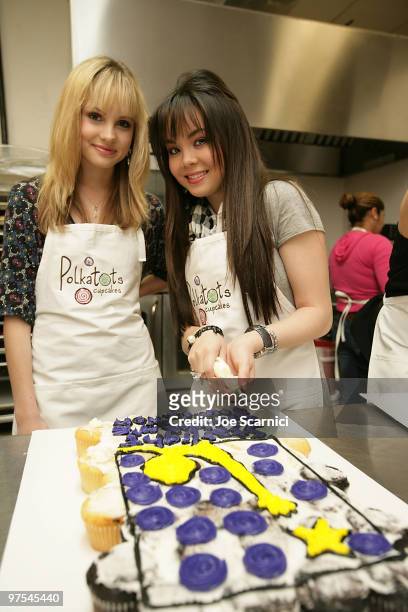Meaghan Martin and Anna Maria Perez de Tagle making cupcakes for the Polkatots Cupcakes celebrity launch party honoring children from Camp Ronald...