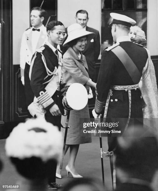 King Bhumibol and Queen Sirikit of Thailand are met by Queen Elizabeth II and the Duke of Edinburgh, upon their arrival at Victoria Station in...