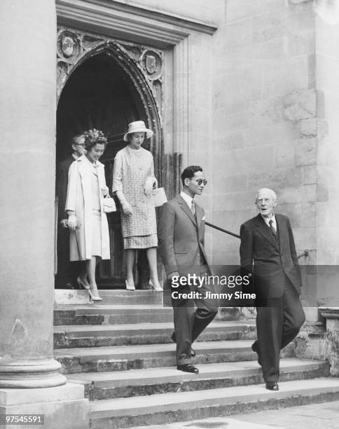 King Bhumibol and Queen Sirikit of Thailand leave Trinity Hall, Trinity College, Cambridge, during their state visit to England, 21st July 1960. They...