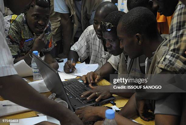 Togolese journalists check the results following the Togolese presidential election on March 6, 2010 in Lome after an annoucement of the results by...