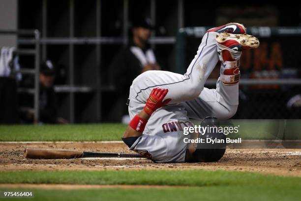 Jose Ramirez of the Cleveland Indians falls to the ground after fouling a pitch off his foot in the fourth inning against the Chicago White Sox at...