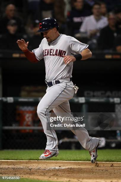 Lonnie Chisenhall of the Cleveland Indians crosses home plate to score a run in the fourth inning against the Chicago White Sox at Guaranteed Rate...