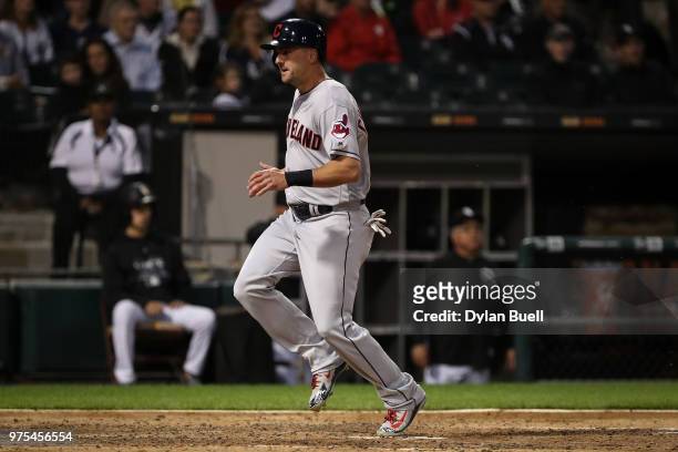 Lonnie Chisenhall of the Cleveland Indians crosses home plate to score a run in the fourth inning against the Chicago White Sox at Guaranteed Rate...