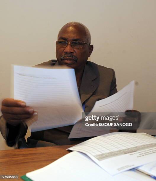 Togolese Electoral Commission chairman Issifou Taffa Tabiou checks the ballots result papers on March 6, 2010 in Lome before making an annoucement....