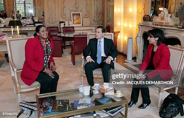 French Immigration Minister Eric Besson , flanked by Sihem Habchi , President of the French Women's rights association "Ni putes ni soumises" ,...