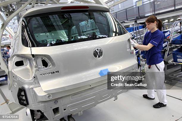 Female worker assembles Volkswagen Golf and Tiguan cars on the assembly line at the VW factory on March 8, 2010 in Wolfsburg, Germany. Volkswagen...