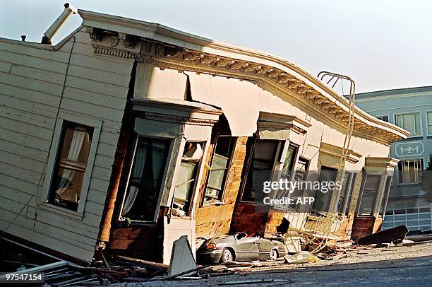 Picture dated 18 October 1989 in San Francisco of a collapsed house that crushed a car parked on the street in the Marina District during a quake...