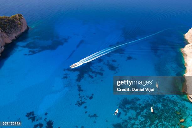 boats at navagio bay in greece. - navagio stock pictures, royalty-free photos & images