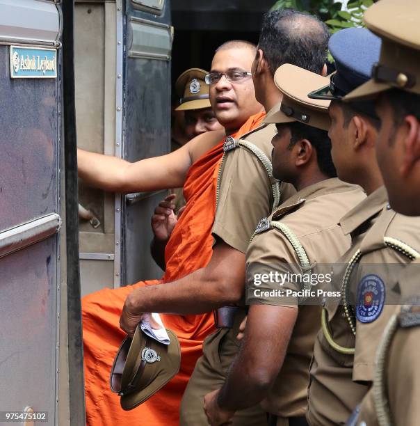 Sri Lankan guards escort Buddhist monk Galagoda Atte Gnanasara after he was sentenced to six months in jail by a magistrate in Homagama on June 14,...