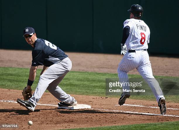 Nick Punto of the Minnesota Twins beats out a hit against first baseman MarkTeiveira of the New York Yankees at Lee County Sports Complex on March 7,...