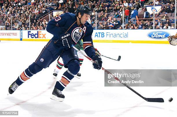 Jason Strudwick of the Edmonton Oilers clears the puck against the Minnesota Wild at Rexall Place on March 5, 2010 in Edmonton, Alberta, Canada. The...