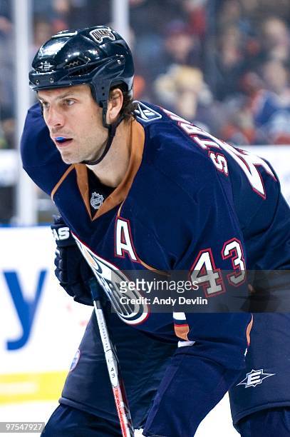 Jason Strudwick of the Edmonton Oilers concentrates on the puck during a game against the Minnesota Wild at Rexall Place on March 5, 2010 in...