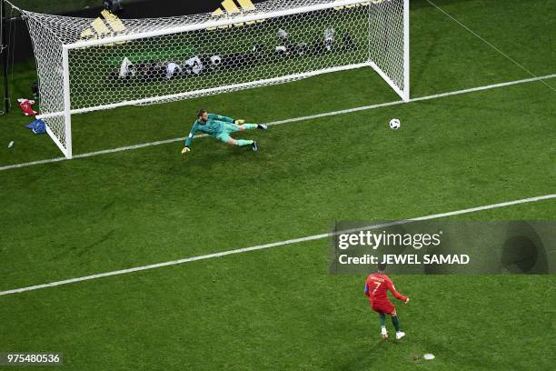 Portugal's forward Cristiano Ronaldo scores a penalty during the Russia 2018 World Cup Group B football match between Portugal and Spain at the Fisht...