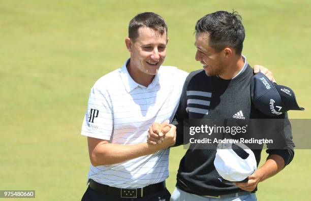 Emiliano Grillo of Argentina and Xander Schauffele of the United States shake hands on the on the 18th green during the second round of the 2018 U.S....