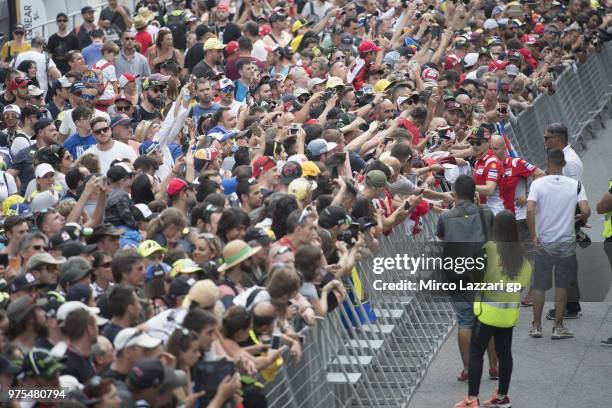 Jorge Lorenzo of Spain and Ducati Team signs autographs for fans in pit during the pit walk during the MotoGp of Catalunya - Free Practice at Circuit...