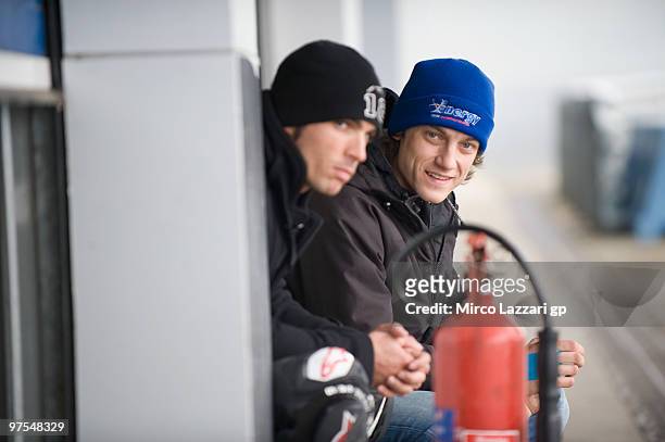 Vladimir Ivanov of Russia and Gresini Racing Moto2 and Toni Elias of Spain Gresini Racing Moto2 look on in front of garage during the third day of...