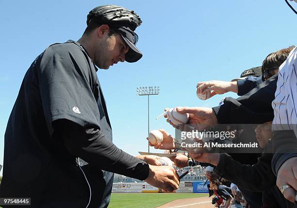 Pitcher Jason Hirsch of the New York Yankees signs autographs before play against the Tampa Bay Rays March 5, 2010 at the George M. Steinbrenner...