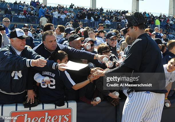Pitcher Jason Hirsch of the New York Yankees signs autographs before play against the Tampa Bay Rays March 5, 2010 at the George M. Steinbrenner...