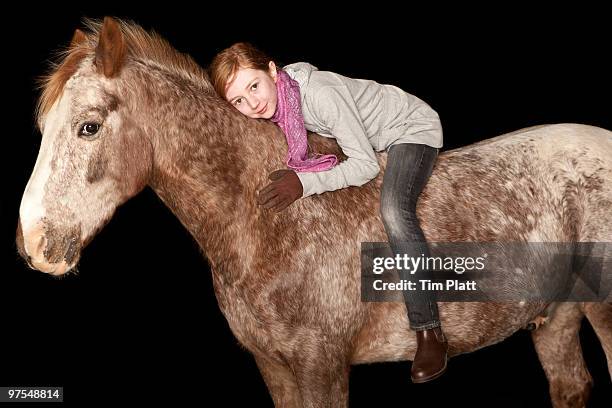 young girl sitting on a horse bareback. - appaloosa stock pictures, royalty-free photos & images