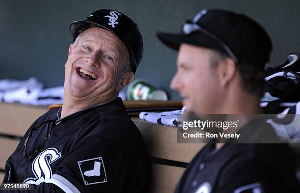Third base coach Jeff Cox laughs while talking to A.J. Pierznski of the Chicago White Sox during a spring training game against the Los Angeles...