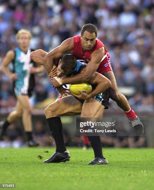 Warren Tredrea for Port Adelaide is tackled by Wayne Schwass for Sydney in the match between Port Power and the Sydney Swans played at Football Park...