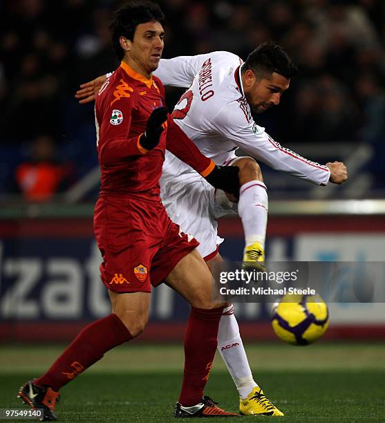 Marco Borriello of Milan shoots past Nicolas Burdisso during the Serie A match between AS Roma and AC Milan at Stadio Olimpico on March 6, 2010 in...