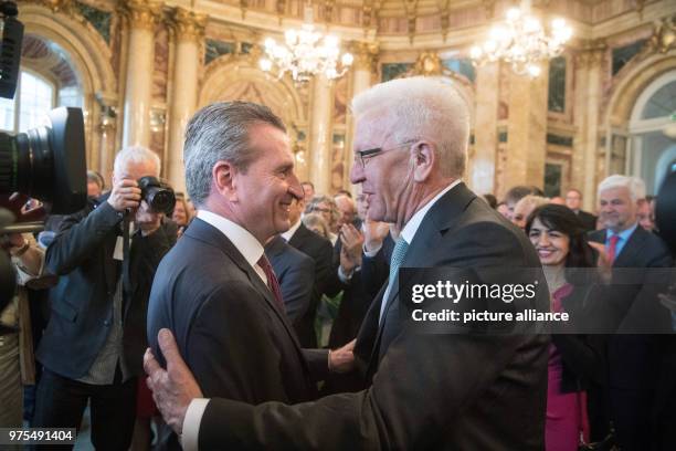 May 2018, Germany, Stuttgart: Premier of Baden-Wuerttemberg Winfried Kretschmann , and Guenther Oettinger , EU Commissioner for Budget and Human...