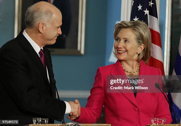 Secretary of State Hillary Clinton and Greek Prime Minister George Papandreou shake hands while speaking to the media after a meeting at the State...