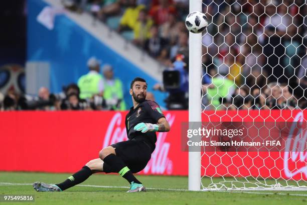 Goalkeeper Rui Patricio of Portugal fails to save a shot from Isco of Spain as ball hits the bar and bounces on the line during the 2018 FIFA World...