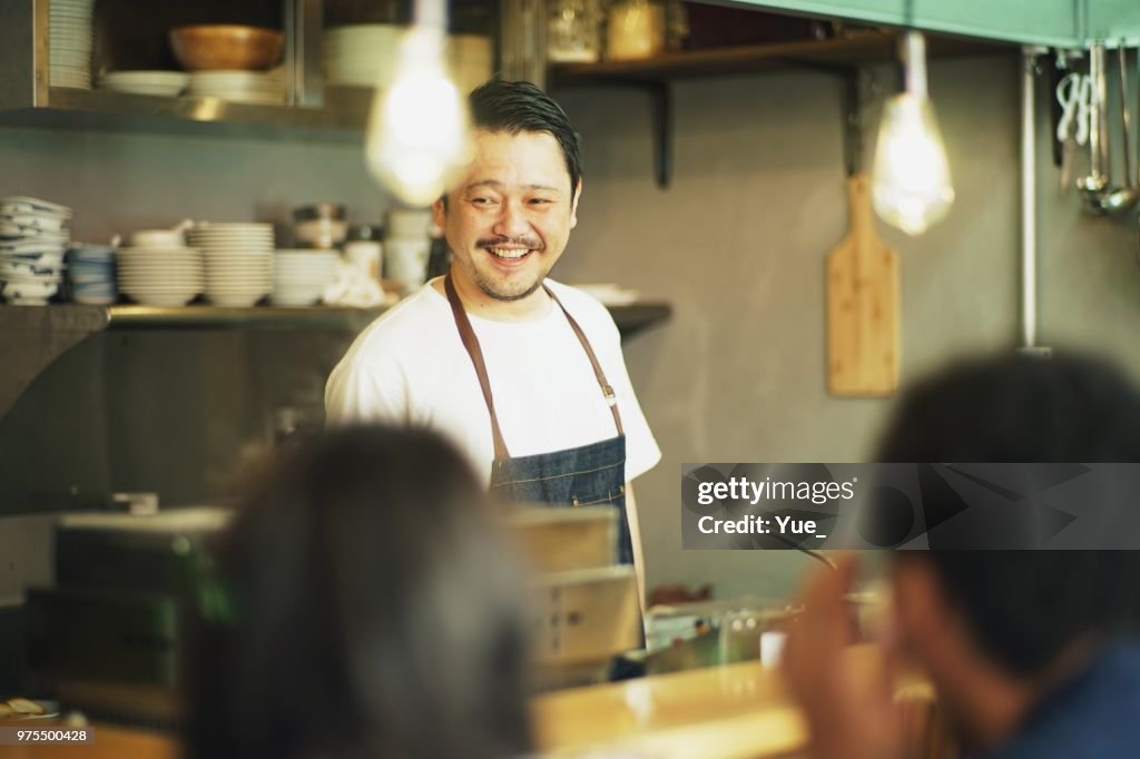 Man cooking in a kitchen at Japanese pub