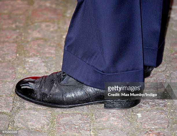 Prince Charles wears what appear to be old tattered shoes as he attends the Commonwealth Day Observance Service at Westminster Abbey on March 8, 2010...
