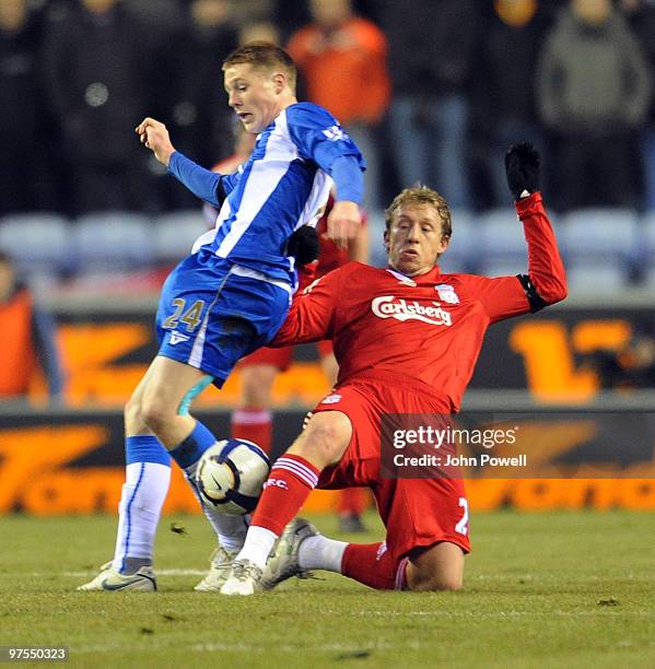 Lucas of Liverpool competes with James McCarthy of Wigan during the Barclays Premier League match between Wigan Athletic and Liverpool at the DW...