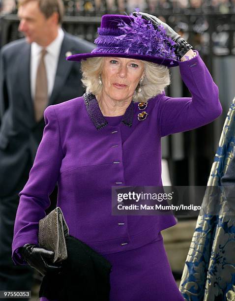 Camilla Duchess of Cornwall holds onto her hat in the high wind as she attends the Commonwealth Day Observance Service at Westminster Abbey on March...